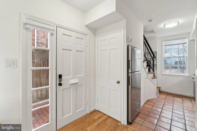 a view of a hallway with wooden floor and entryway