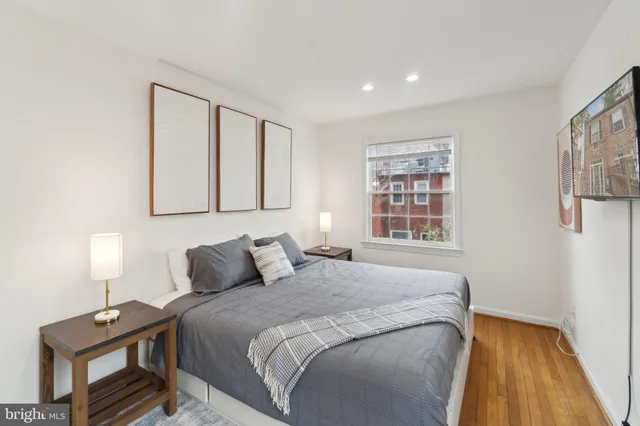 a bedroom with a bed and a night stand