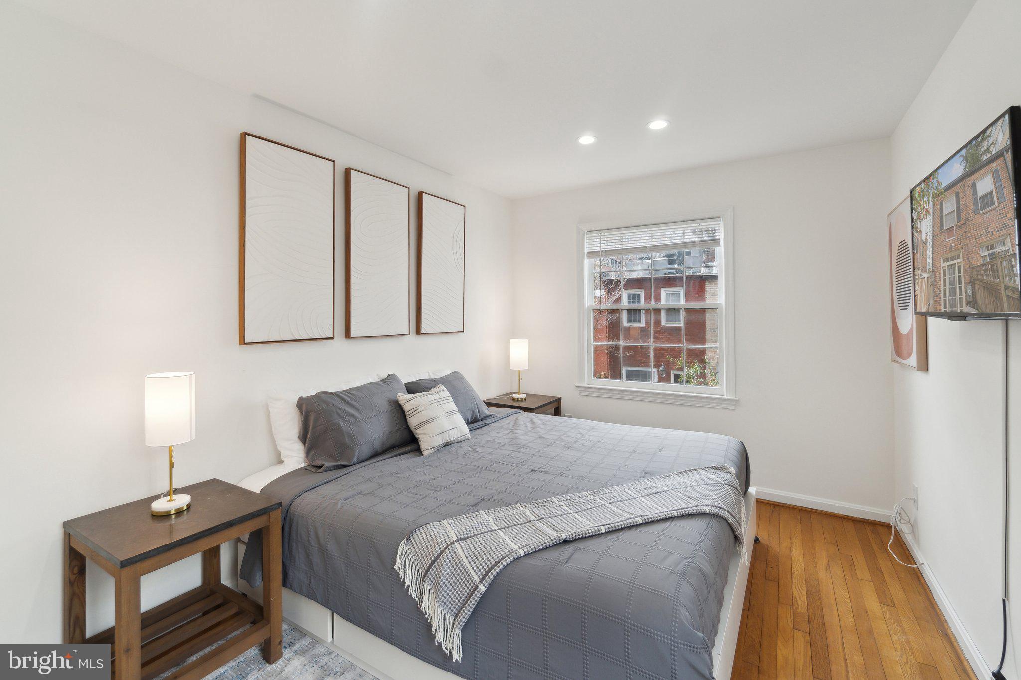 19 Snows Court Northwest Washington, DC 20037 - Photo 10 of 21 a bedroom with a bed and a night stand