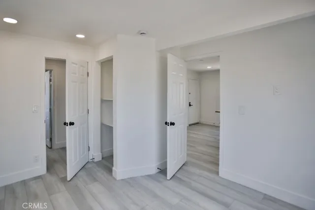 a view of a hallway with wooden floor