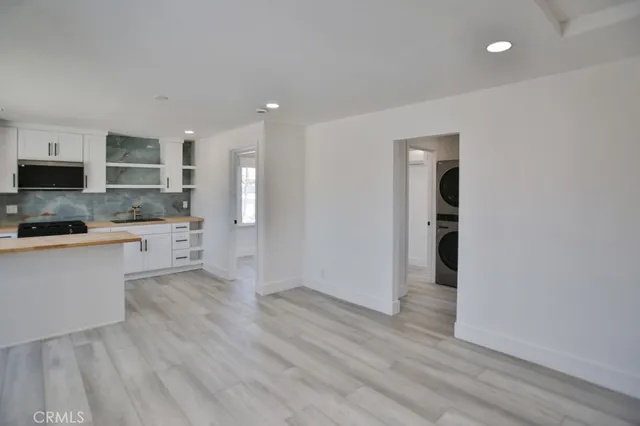 a view of a kitchen with a sink and a stove top oven