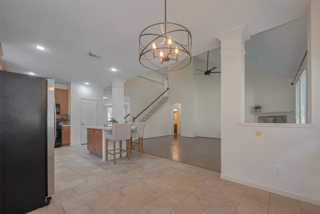 a kitchen with stainless steel appliances granite countertop a stove a sink dishwasher and a microwave oven with cabinets