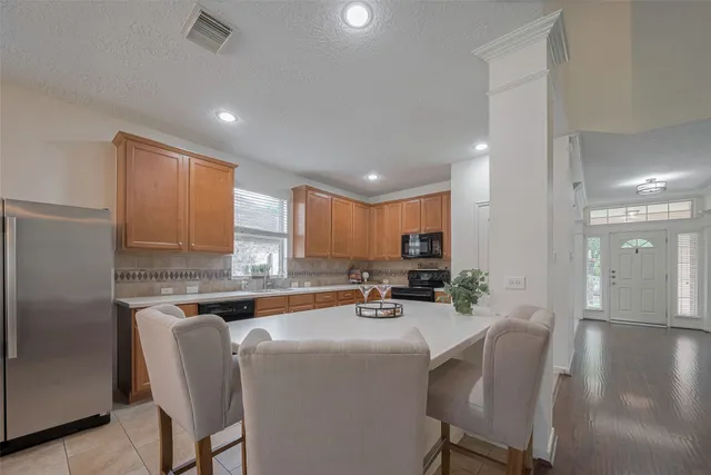 a kitchen with stainless steel appliances granite countertop a sink counter space cabinets and a large window