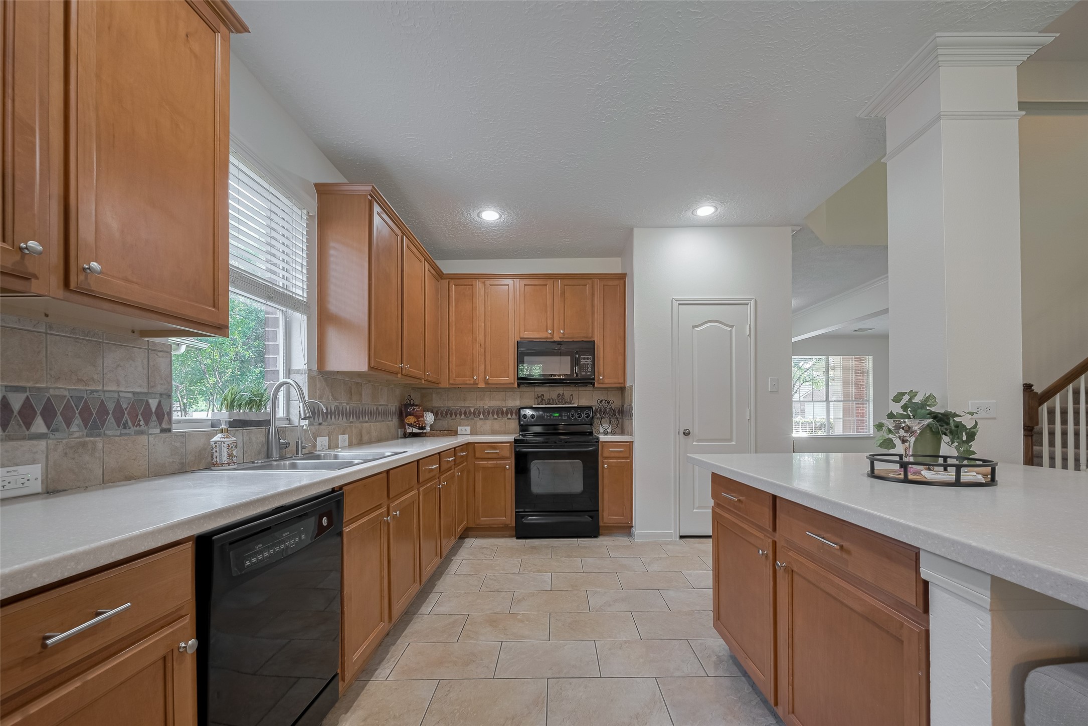 31214 Windcrest Park Lane Spring, TX 77386 - Photo 18 of 45 a kitchen with stainless steel appliances granite countertop a sink counter space cabinets and a large window