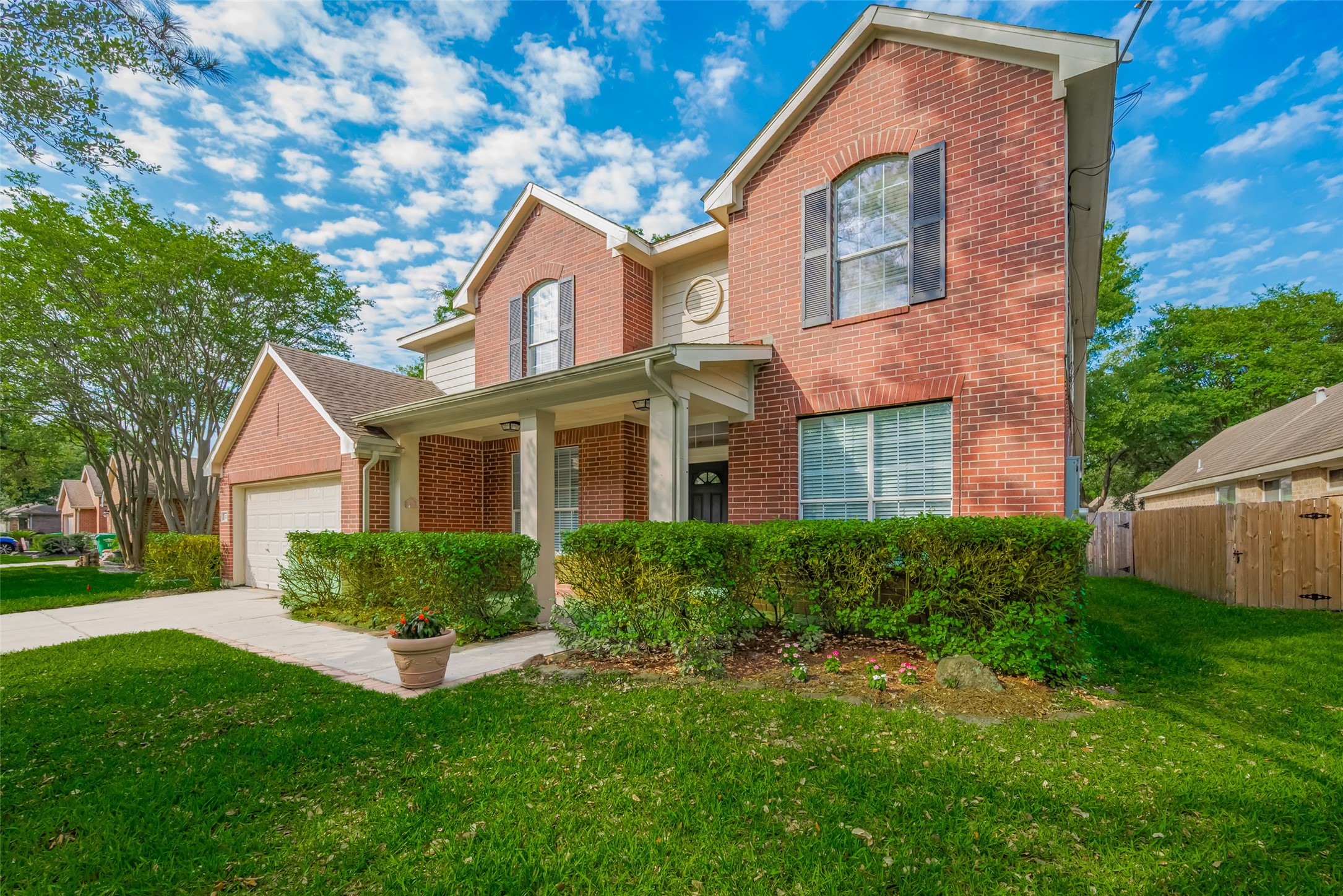 31214 Windcrest Park Lane Spring, TX 77386 - Photo 2 of 45 a front view of a house with a yard and porch