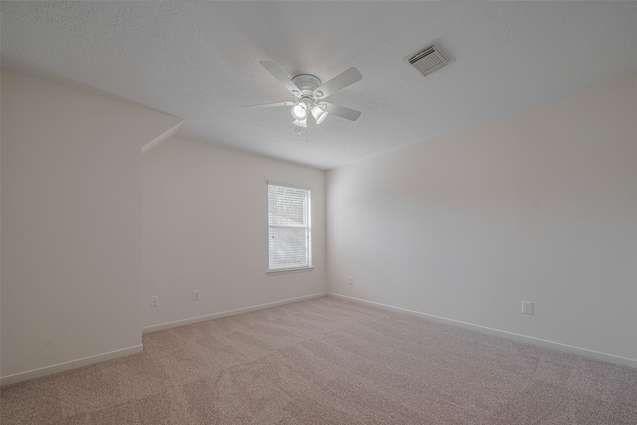 31214 Windcrest Park Lane Spring, TX 77386 - Photo 25 of 45 an empty room with a window and a fan