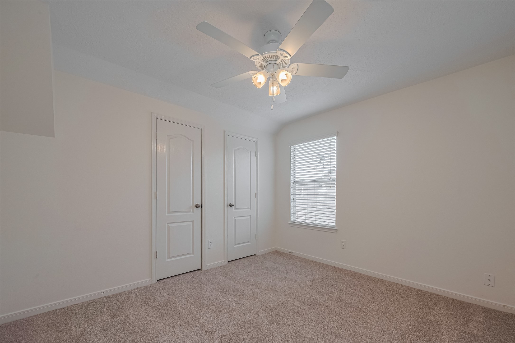 31214 Windcrest Park Lane Spring, TX 77386 - Photo 31 of 45 an empty room with windows and fan