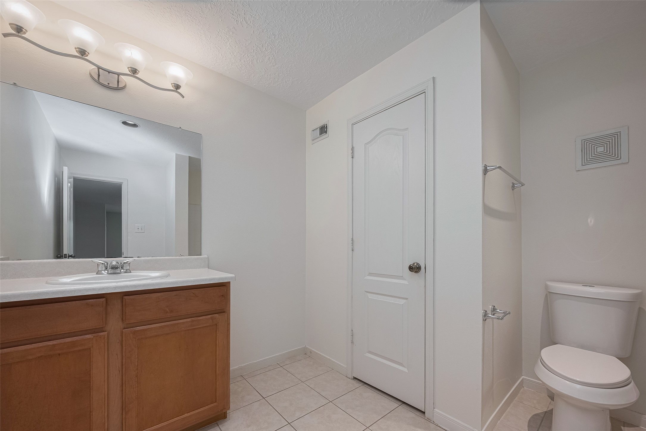 31214 Windcrest Park Lane Spring, TX 77386 - Photo 33 of 45 a bathroom with a sink a toilet and mirror