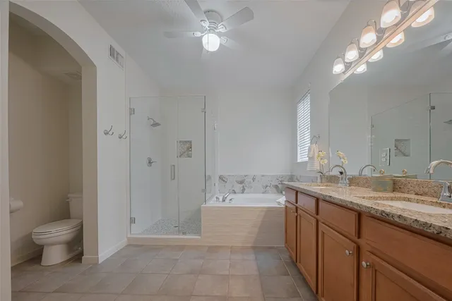 a bathroom with a bathtub a double vanity sink and a mirror