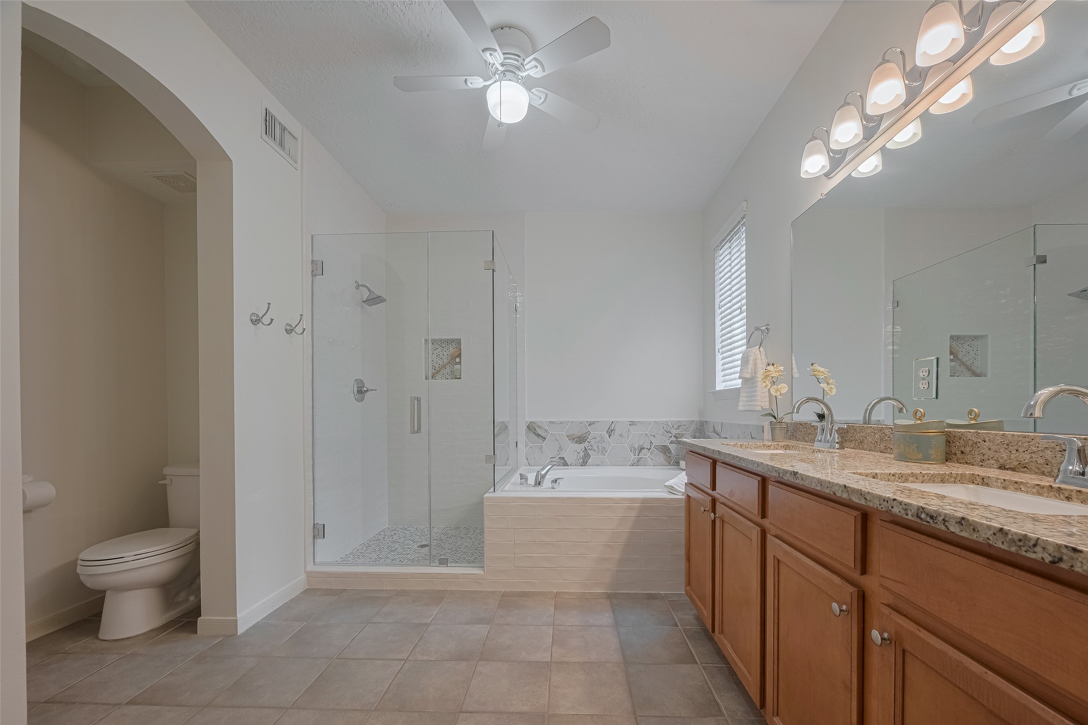 31214 Windcrest Park Lane Spring, TX 77386 - Photo 38 of 45 a bathroom with a granite countertop sink a toilet and a mirror