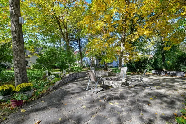 a view of backyard with a table and chairs and potted plants