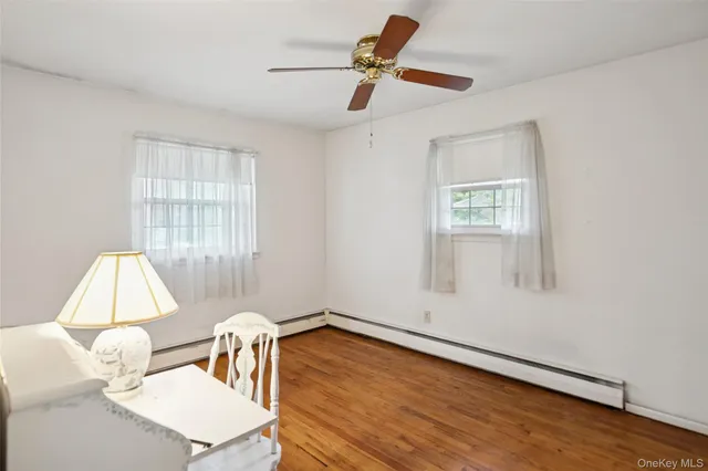 a dining room with wooden floor a glass table and chairs