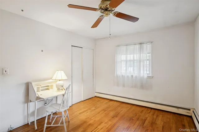 a view of a room with furniture and wooden floor