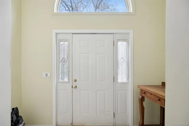 a view of a livingroom with wooden floor and a fireplace