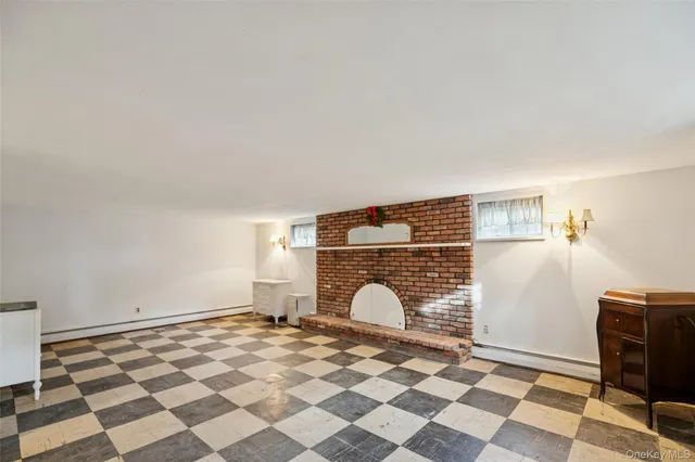 a view of a livingroom with a chair and a fireplace