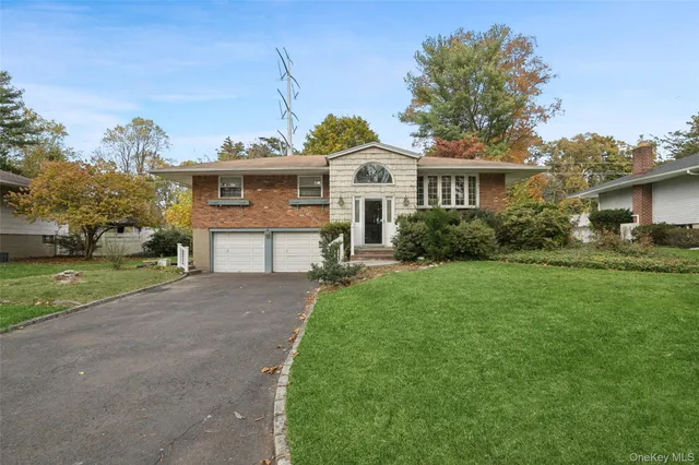 a view of a house with a yard and potted plants