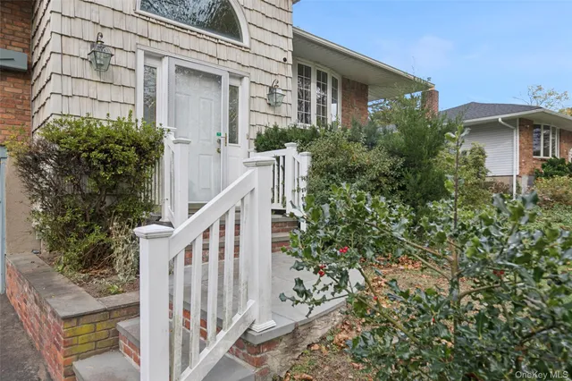 a view of a house with a big yard and large trees