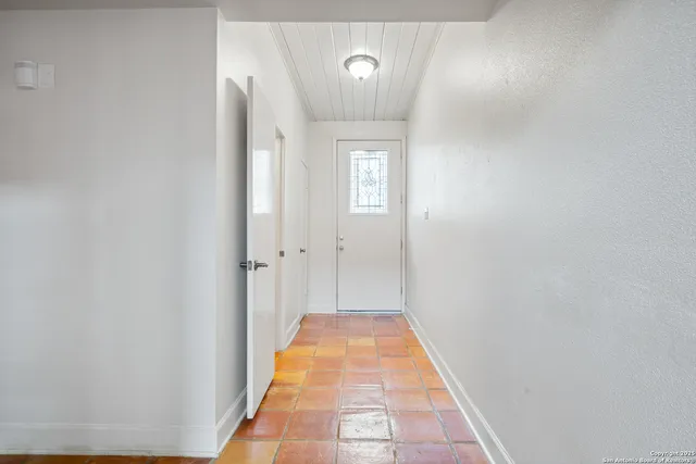 a view of a hallway with a white walls