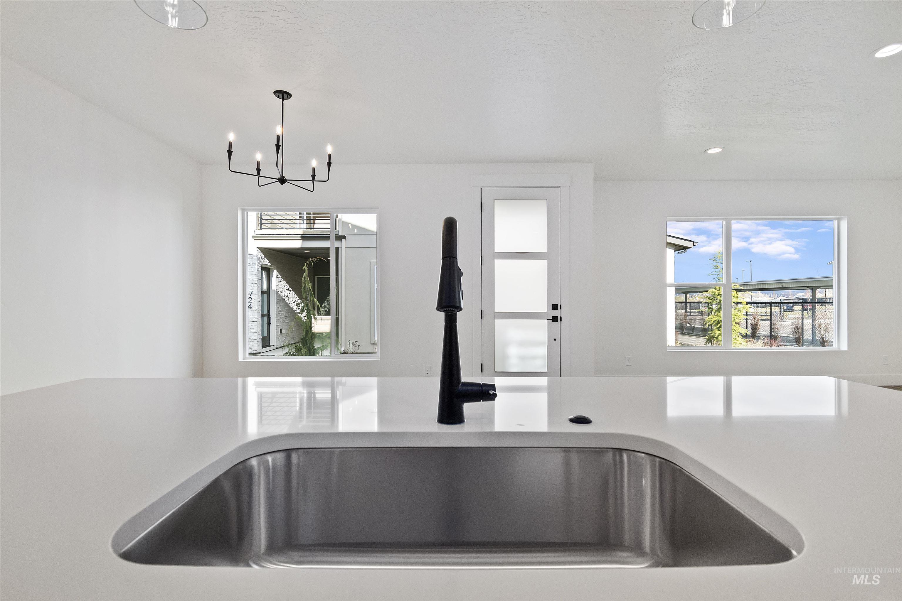 764 South Calhoun Lane Star, ID 83669 - Photo 12 of 48 Kitchen with hanging light fixtures, recessed lighting, and light stone countertops