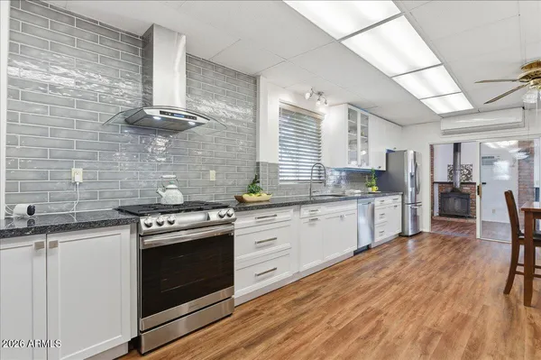 a kitchen with stainless steel appliances granite countertop a stove and a sink
