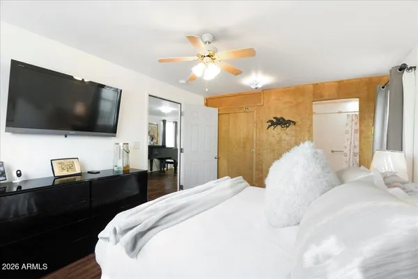 a spacious bedroom with a bed and a window