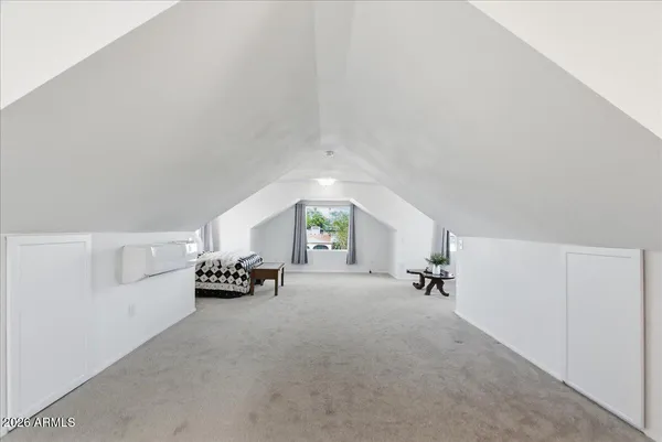 a bedroom with furniture and a window