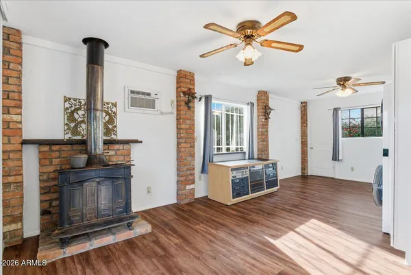 a view of a room with wooden floor and windows