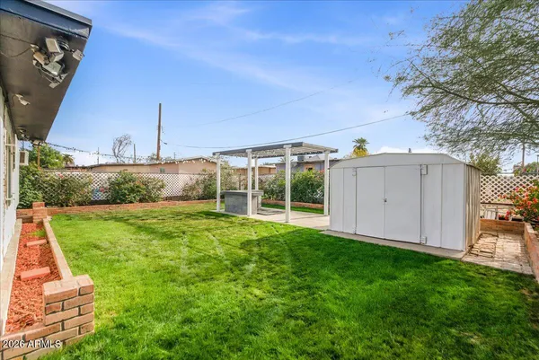 a view of a house with backyard and porch