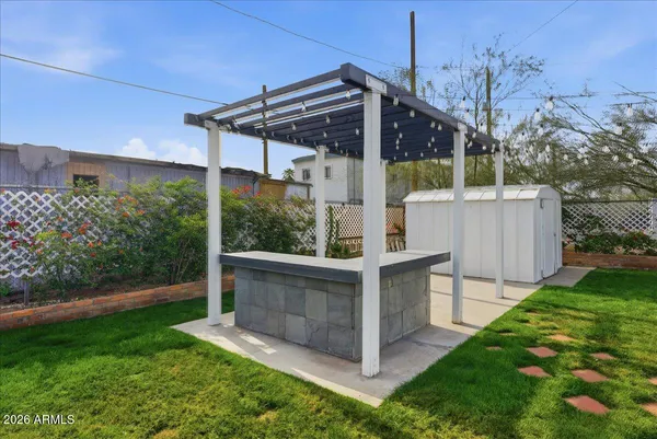 a view of a patio with a table and chairs