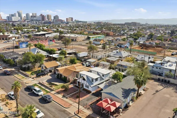 an aerial view of residential houses with city view