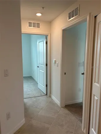 a large kitchen with granite countertop a stove a sink a microwave and a refrigerator