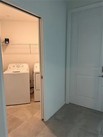 a kitchen with kitchen island granite countertop a stove a sink a microwave and a refrigerator