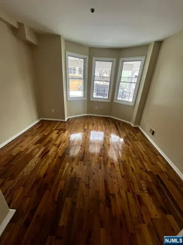 a view of room with window and hardwood floor
