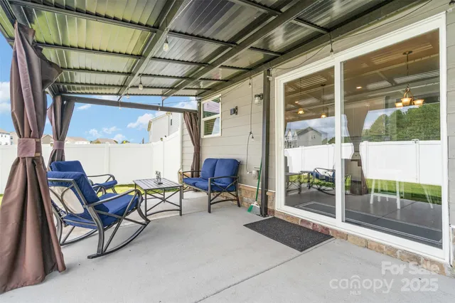 a view of a house with backyard and sitting area