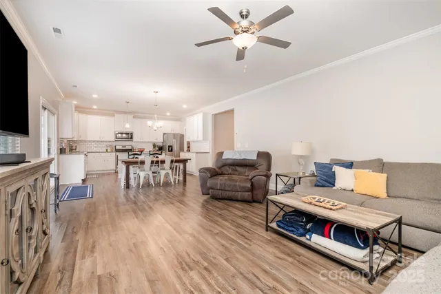 a view of a dining room with furniture and a chandelier