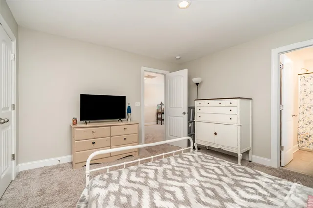 a bathroom with a granite countertop toilet sink and mirror