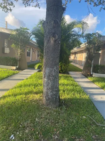 a view of a yard and front view of a house