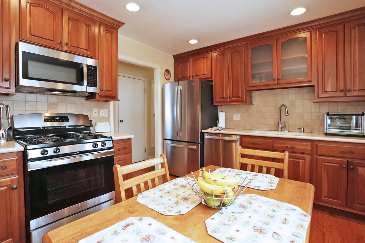 640 Edgemont Lane Hoffman Estates, IL 60169 - Photo 11 of 30 a kitchen with stainless steel appliances granite countertop a stove top oven a dining table and chairs