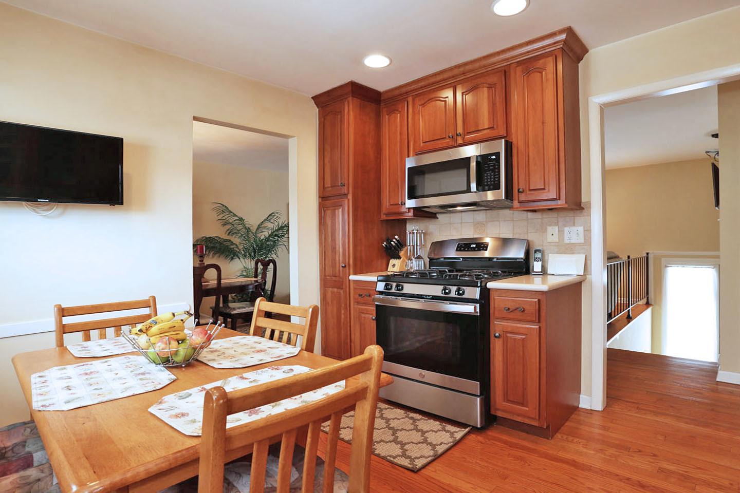 640 Edgemont Lane Hoffman Estates, IL 60169 - Photo 9 of 30 a kitchen with stainless steel appliances granite countertop a stove top oven a sink a dining table and chairs