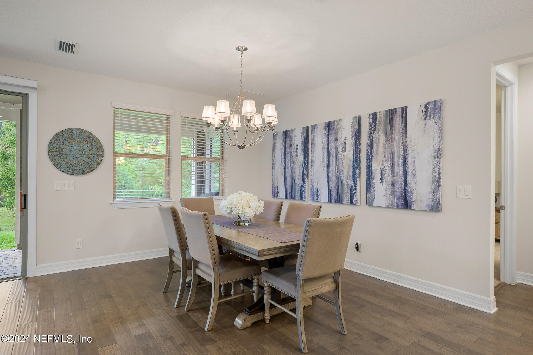 91 Broomsedge Circle St. Augustine, FL 32095 - Photo 13 of 45 a view of a dining room with furniture window and wooden floor