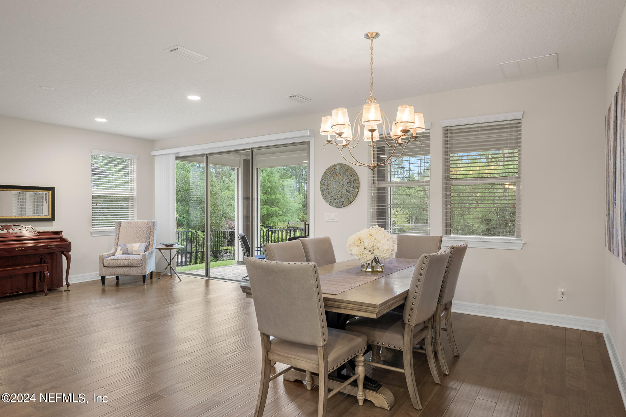 91 Broomsedge Circle St. Augustine, FL 32095 - Photo 14 of 45 a dining room with furniture a chandelier and wooden floor