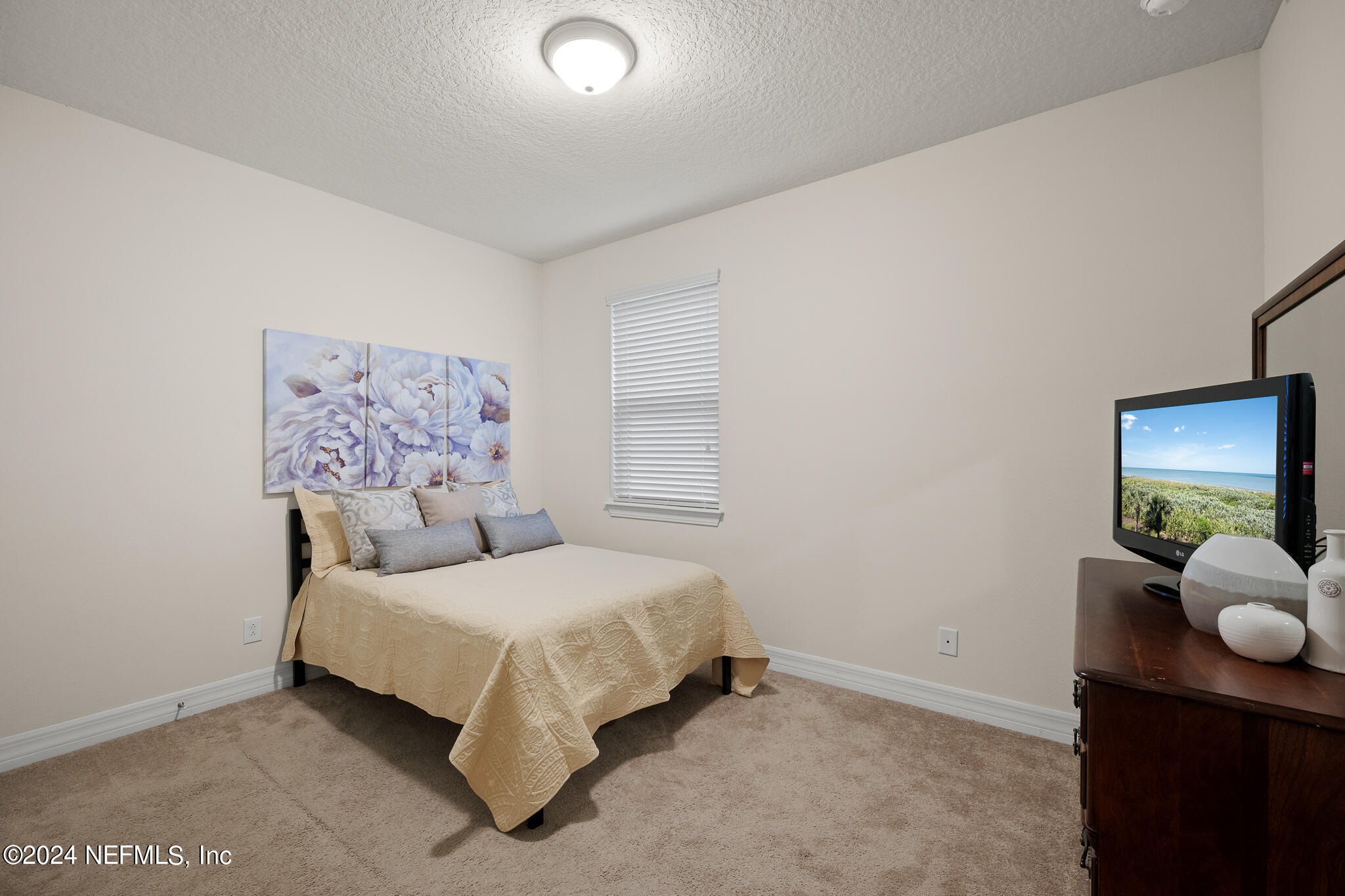 91 Broomsedge Circle St. Augustine, FL 32095 - Photo 28 of 45 a bedroom with a bed and lamp
