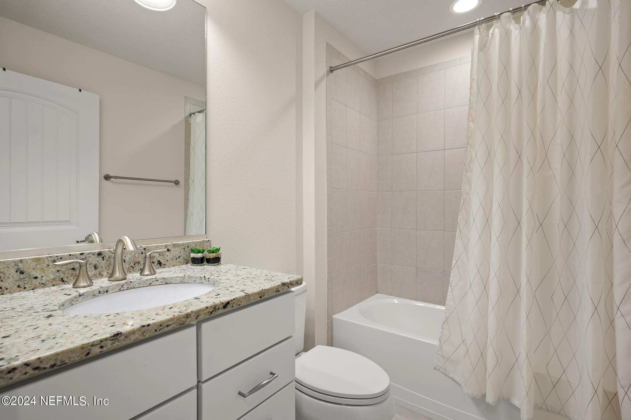91 Broomsedge Circle St. Augustine, FL 32095 - Photo 30 of 45 a bathroom with a granite countertop sink toilet and shower