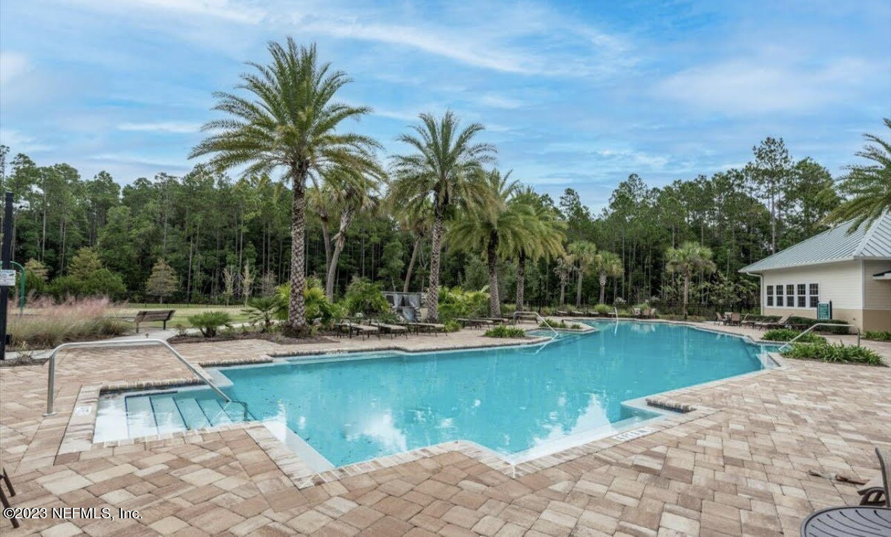 91 Broomsedge Circle St. Augustine, FL 32095 - Photo 42 of 45 a view of a swimming pool and lounge chairs