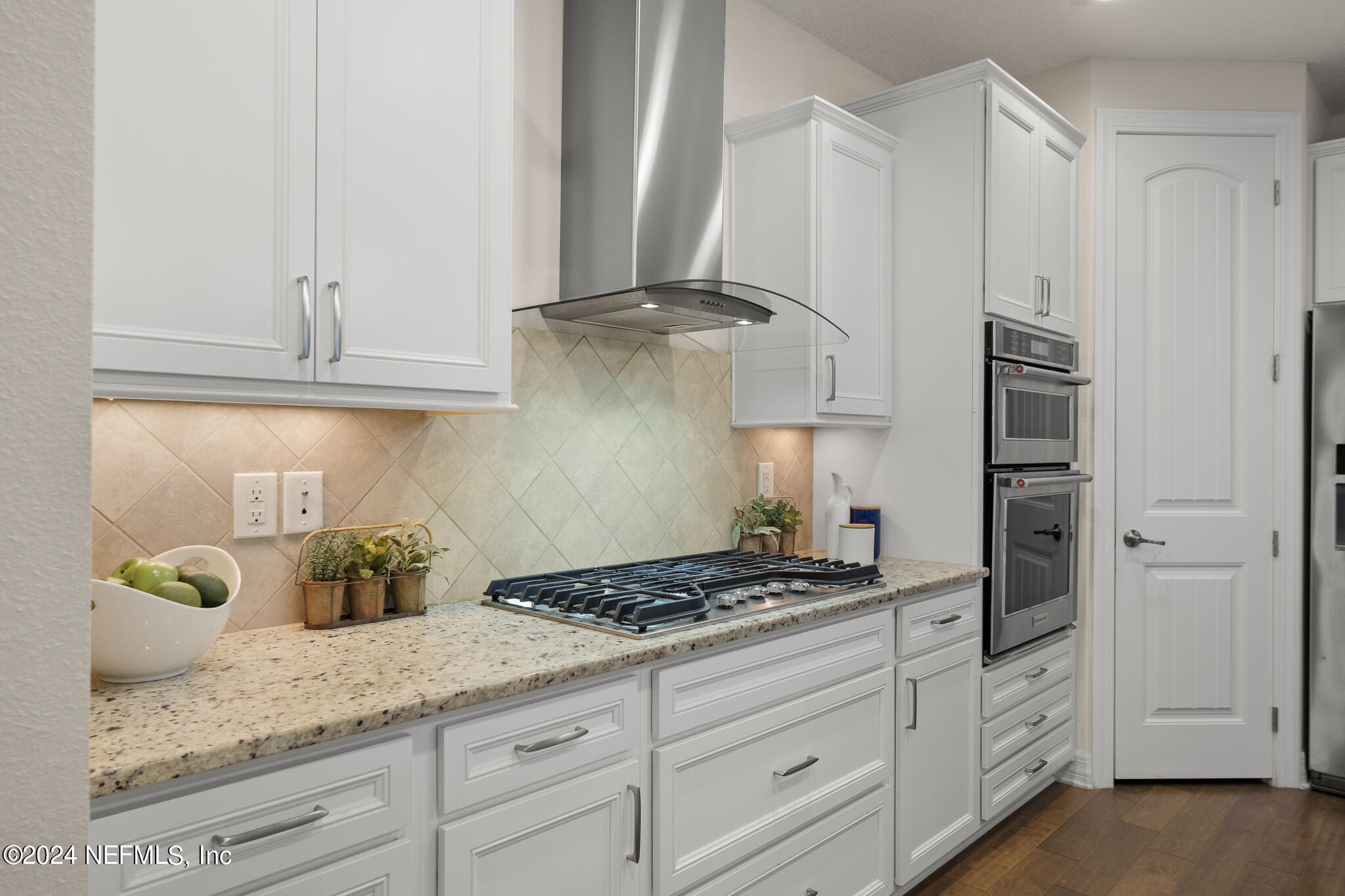 91 Broomsedge Circle St. Augustine, FL 32095 - Photo 9 of 45 a kitchen with granite countertop white cabinets and white appliances