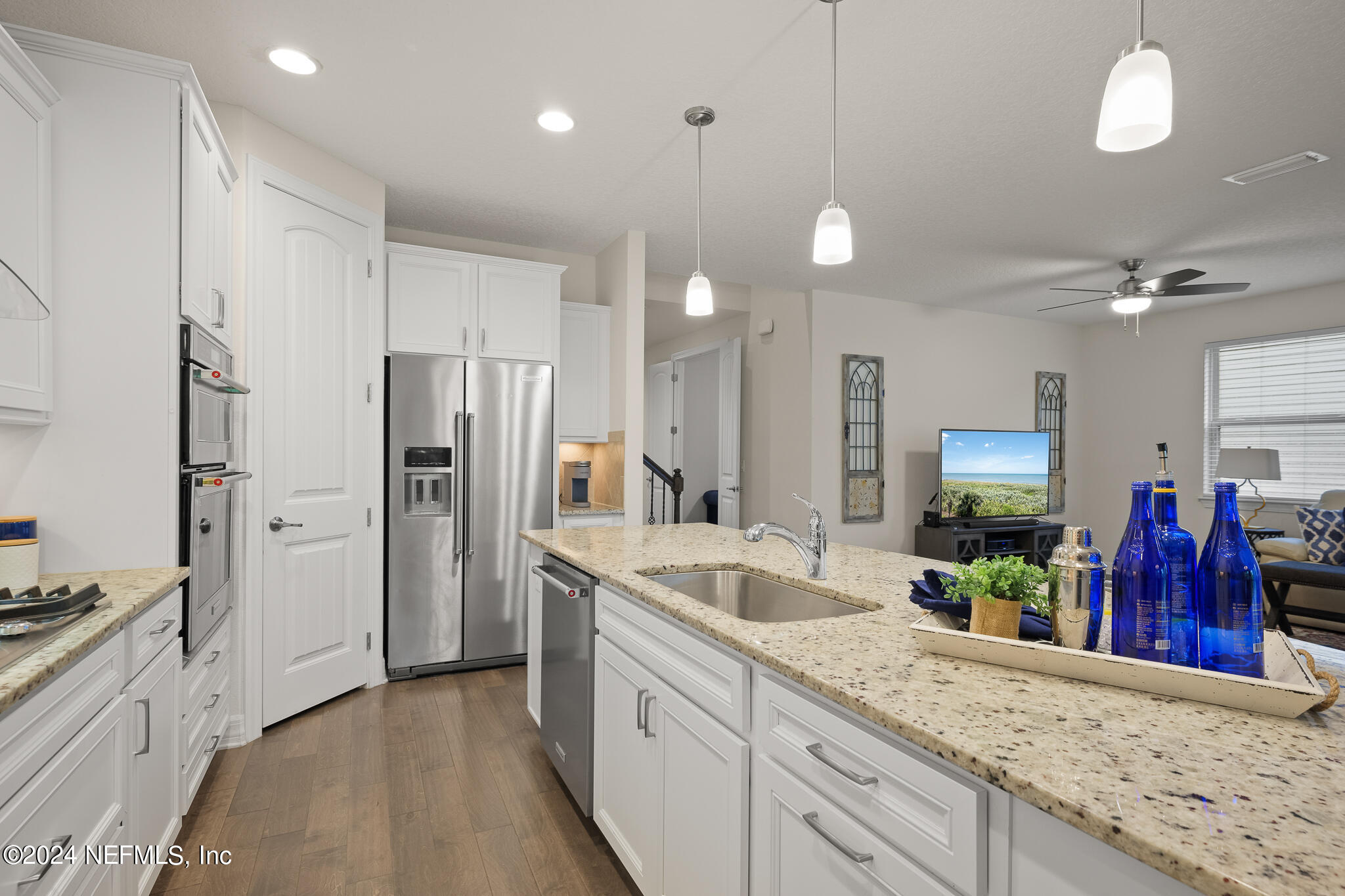 91 Broomsedge Circle St. Augustine, FL 32095 - Photo 10 of 45 a large kitchen with stainless steel appliances kitchen island granite countertop a refrigerator and a sink