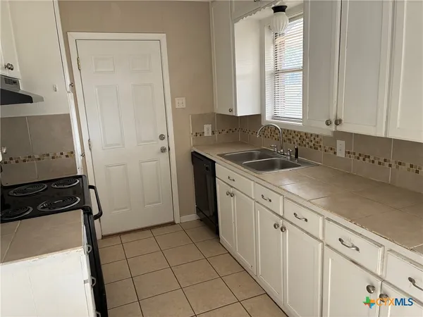 a kitchen with a sink and cabinets