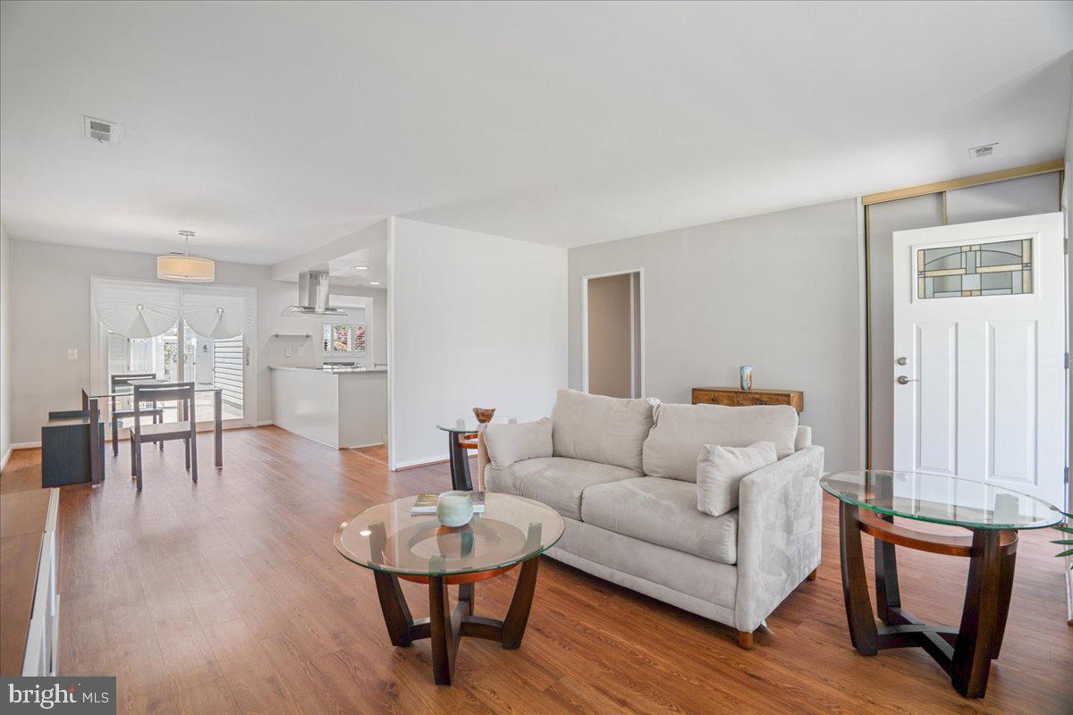 14515 Fiske Drive, Unit 160A Silver Spring, MD 20906 - Photo 1 of 20 a living room with furniture and wooden floor