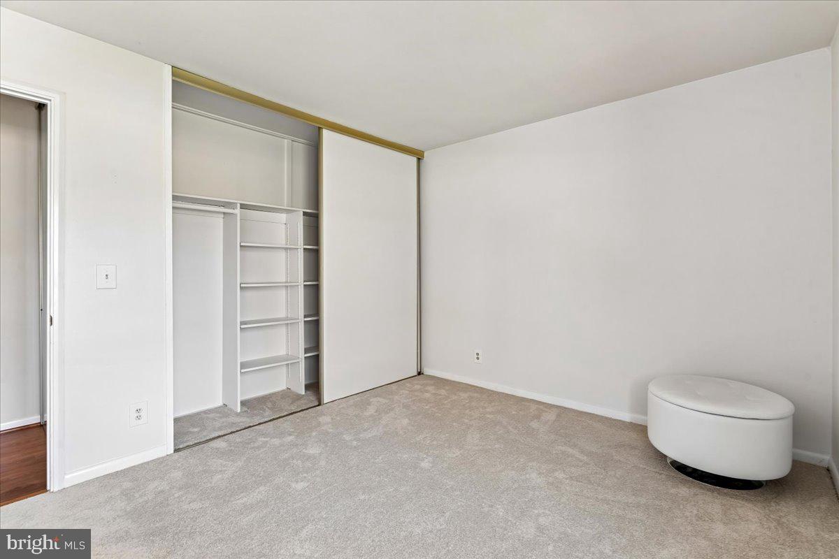 14515 Fiske Drive, Unit 160A Silver Spring, MD 20906 - Photo 14 of 20 an empty room with a bench and white paint