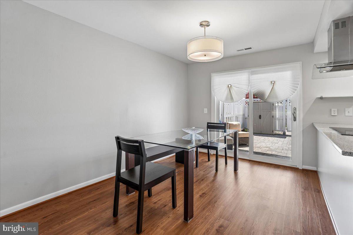 14515 Fiske Drive, Unit 160A Silver Spring, MD 20906 - Photo 6 of 20 a view of a dining room with furniture and wooden floor